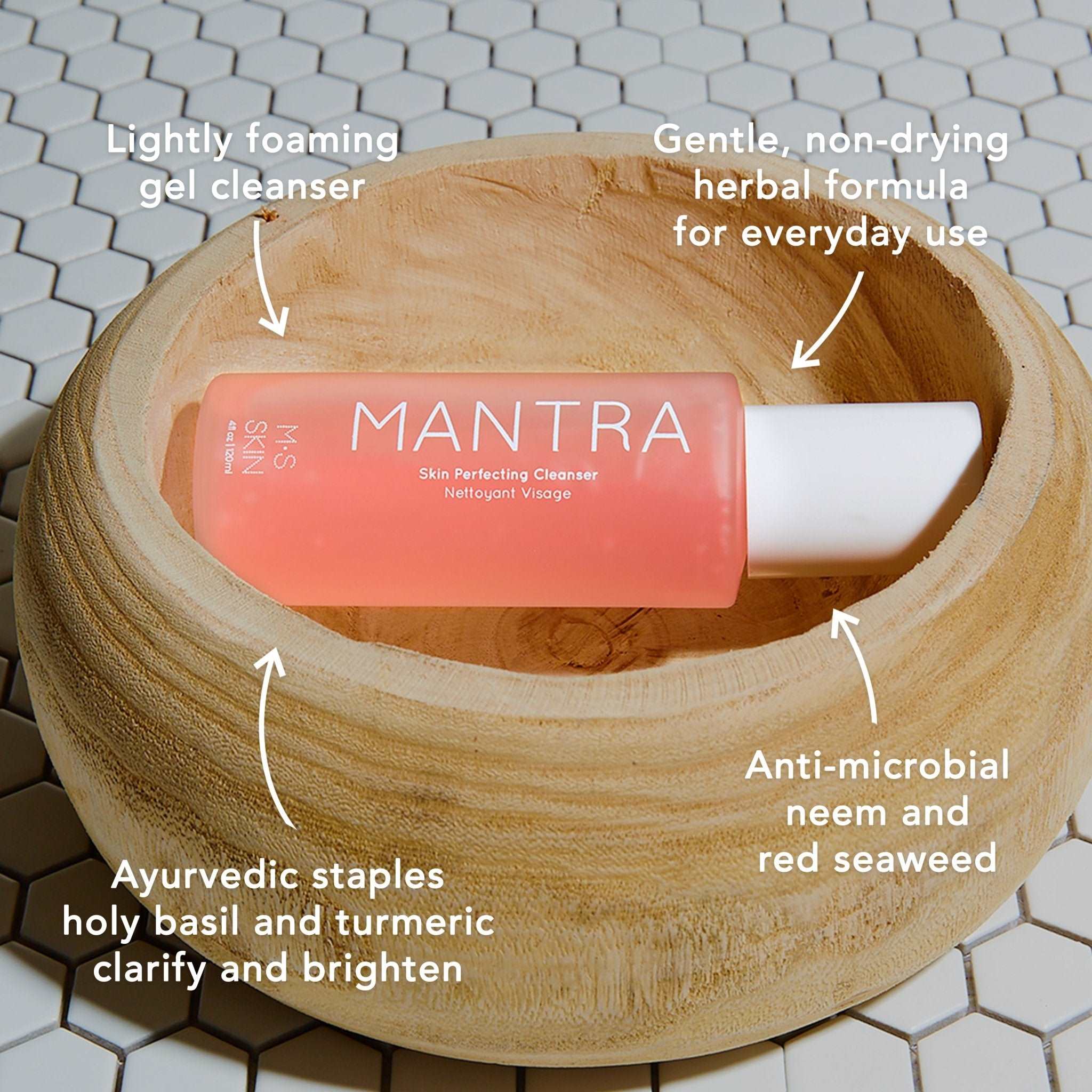 M.S Skincare MANTRA Skin Perfecting Cleanser -Ayurvedic Pink gel in a frosted white bottle with white printing in a wood bowl